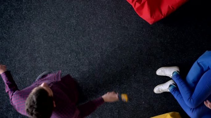 多莉-男子跳绳和女子玩球坐在彩色软包上的最佳镜头。