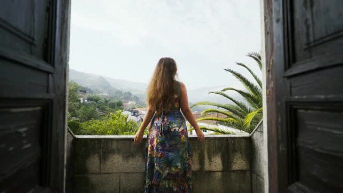 站在葡萄牙别墅阳台上的年轻女士