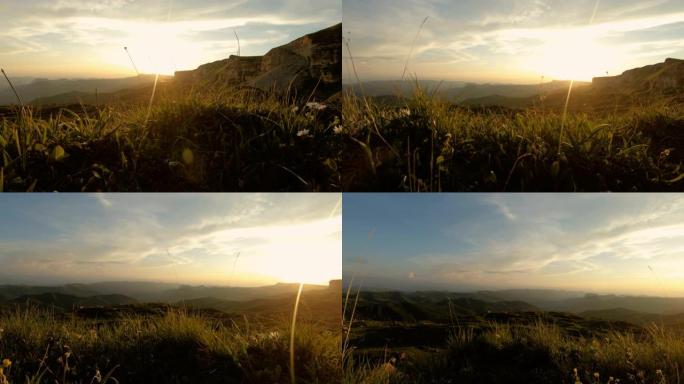 低矮的落日天空在岩石山谷中云密布。日落时岩石块脚下的地形全景。4k暖灯