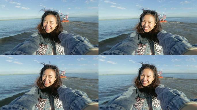 亚洲女人放松，早上在旅游船上看湖景，慢动作，概念女人独自旅行