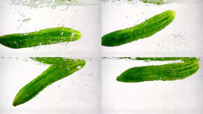 绿色新鲜黄瓜在白色背景上掉入水中