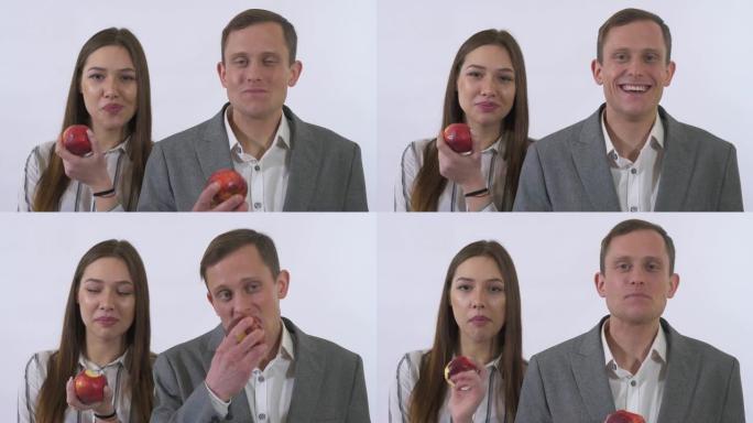 特写肖像年轻夫妇吃红苹果