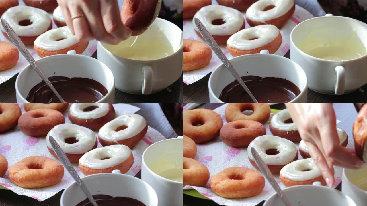 一名妇女将用葵花籽油油炸的美国甜甜圈浸入融化的巧克力中。