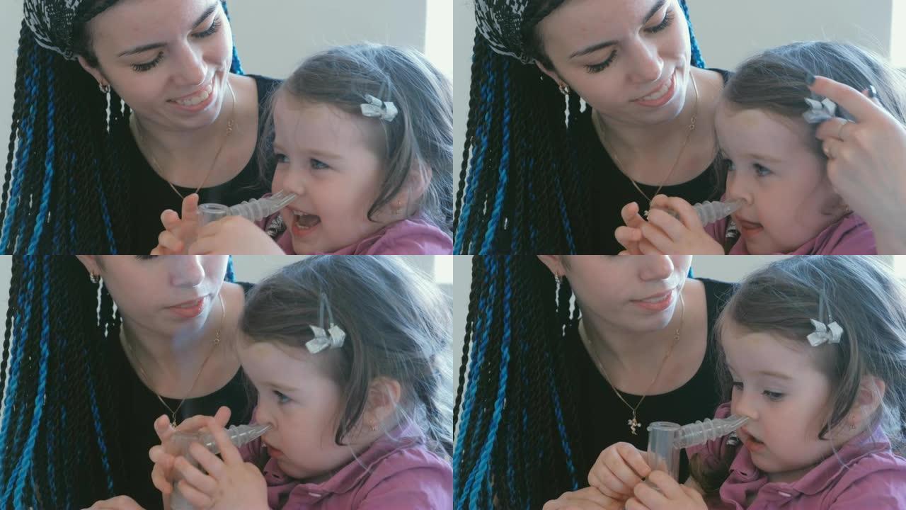 可爱的小女孩和妈妈一起通过吸入器面罩吸气。使用雾化器和吸入器进行治疗。