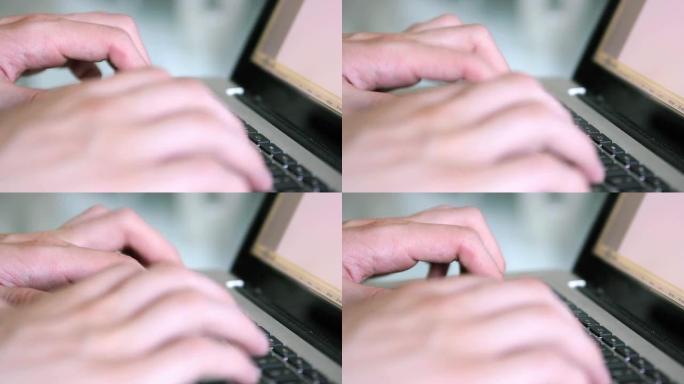 男子在Macbook笔记本电脑上打字。