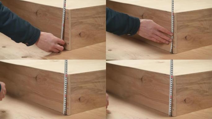 男子手持柔性尺子测量木箱高度的特写镜头