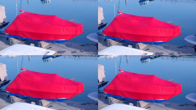 海港覆盖着红色篷布的船停在码头上。