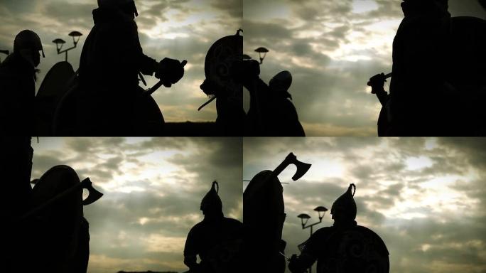 中世纪的战斗。带有剑，斧头，盾牌的战士的剪影