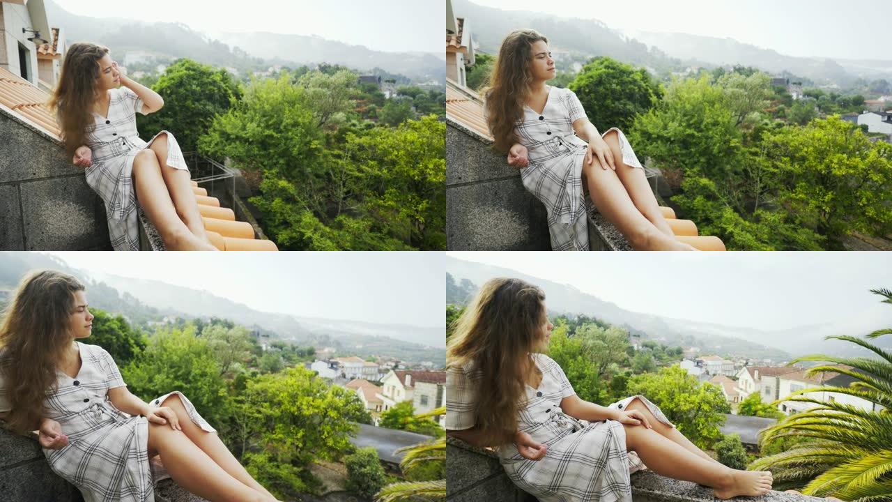 阳台上的年轻女士欣赏风景