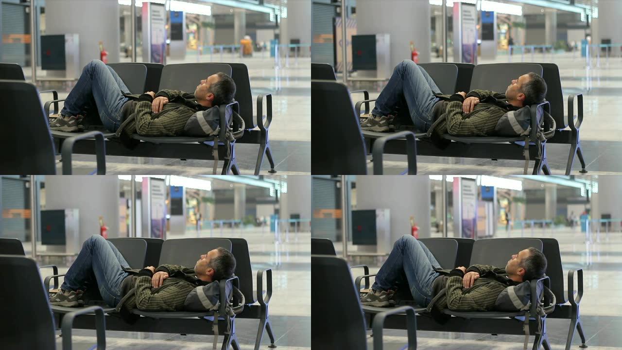 年轻人在机场客运大楼等机时睡觉