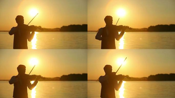 小提琴家男人在日落时演奏小提琴