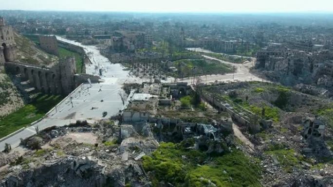 蓝天下，阿勒颇街道上的建筑废墟和绿色自然空间的鸟瞰图。我们可以在背景中看到整个阿勒颇市。