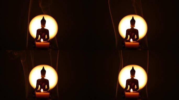 蜡烛和侧向熏香的佛像