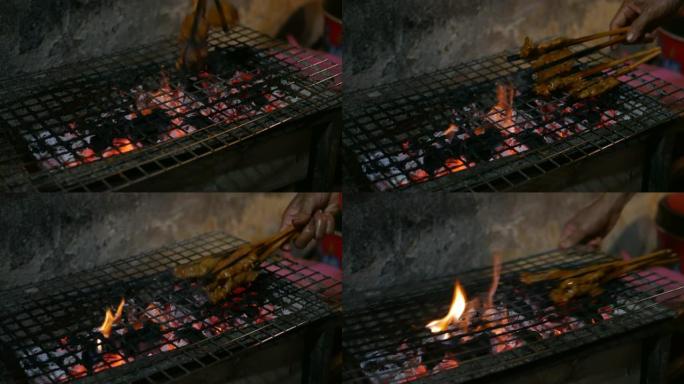 街头小贩准备并出售烧烤猪肉，在夜市烧烤炸猪肉。收尾.4k