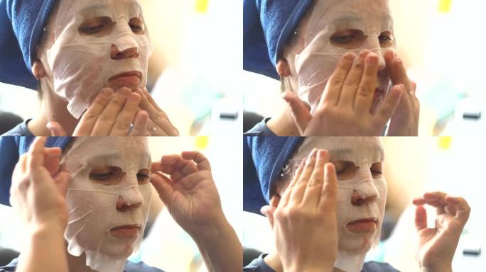 一个女人在脸上戴上纸质化妆品面膜