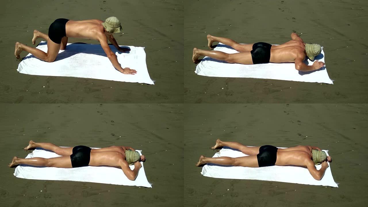 一个人独自掉在沙滩上的毛巾上，无所事事