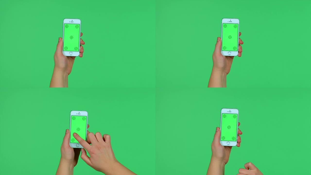 智能手机在绿色屏幕上轻按，滑动，展开，捏手势