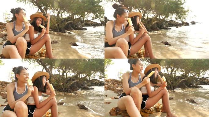 两名年轻女子坐在沙滩上放松