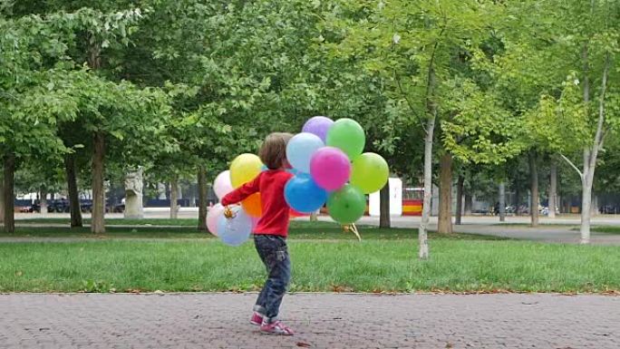 小女孩玩彩色气球，慢动作