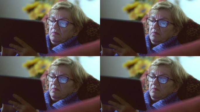 女人在平板电脑上使用facebook: 眼镜上的反射
