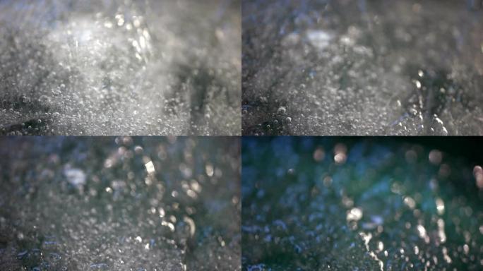 融雪融冰冰山全球变暖效应。闪亮融化的雪粒变成液态水的宏观延时拍摄。