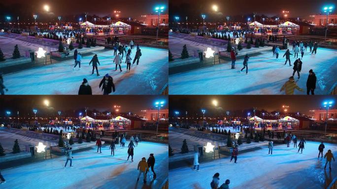 很多人晚上在城市公园滑冰。