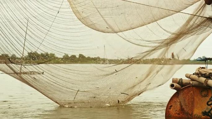 中国渔网和渔夫用手网捕捞鱼类的河流水位视图
