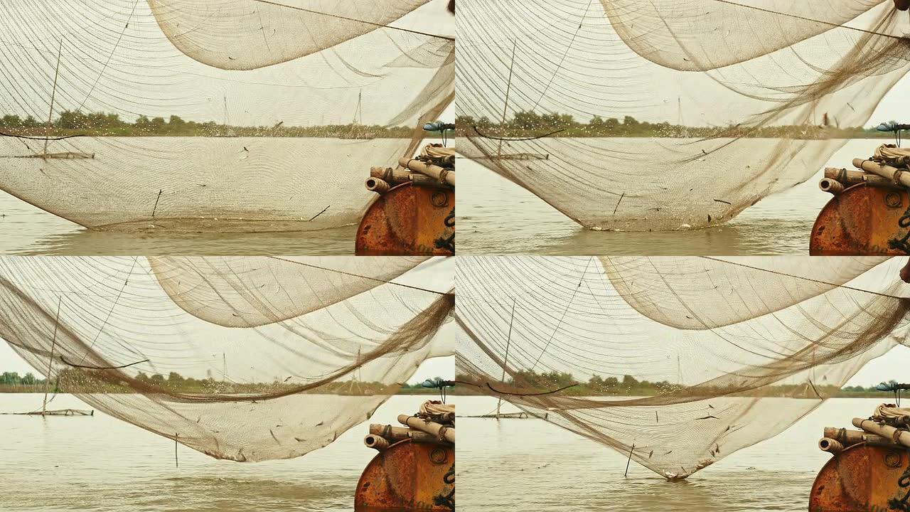 中国渔网和渔夫用手网捕捞鱼类的河流水位视图