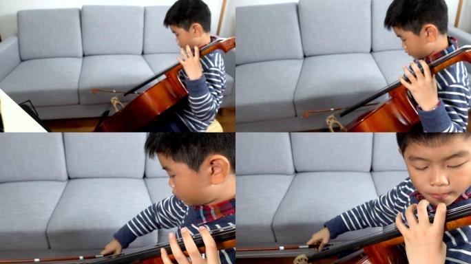 亚洲男孩在室内学习大提琴