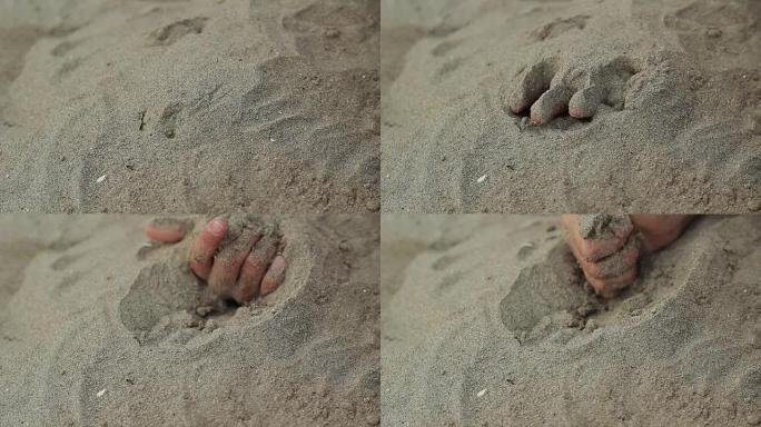 用沙子掩埋的手