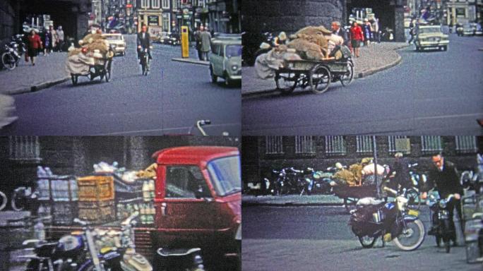 德国科隆——1966年:一个穷人骑着自行车穿过城市，带着大量不知名的商品。