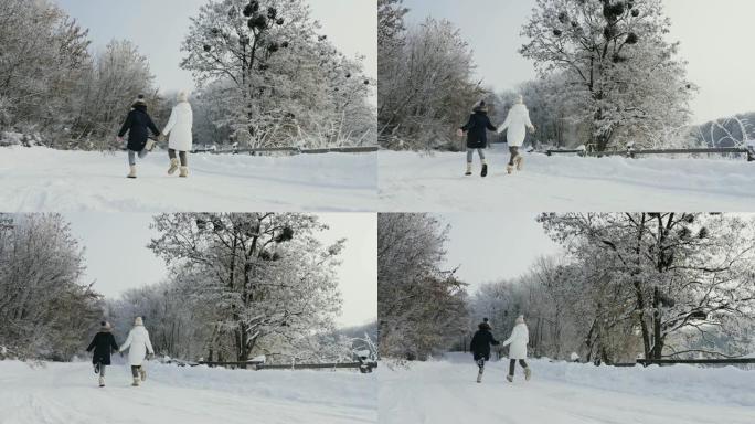 妈妈和女儿在冬天在大自然中玩耍