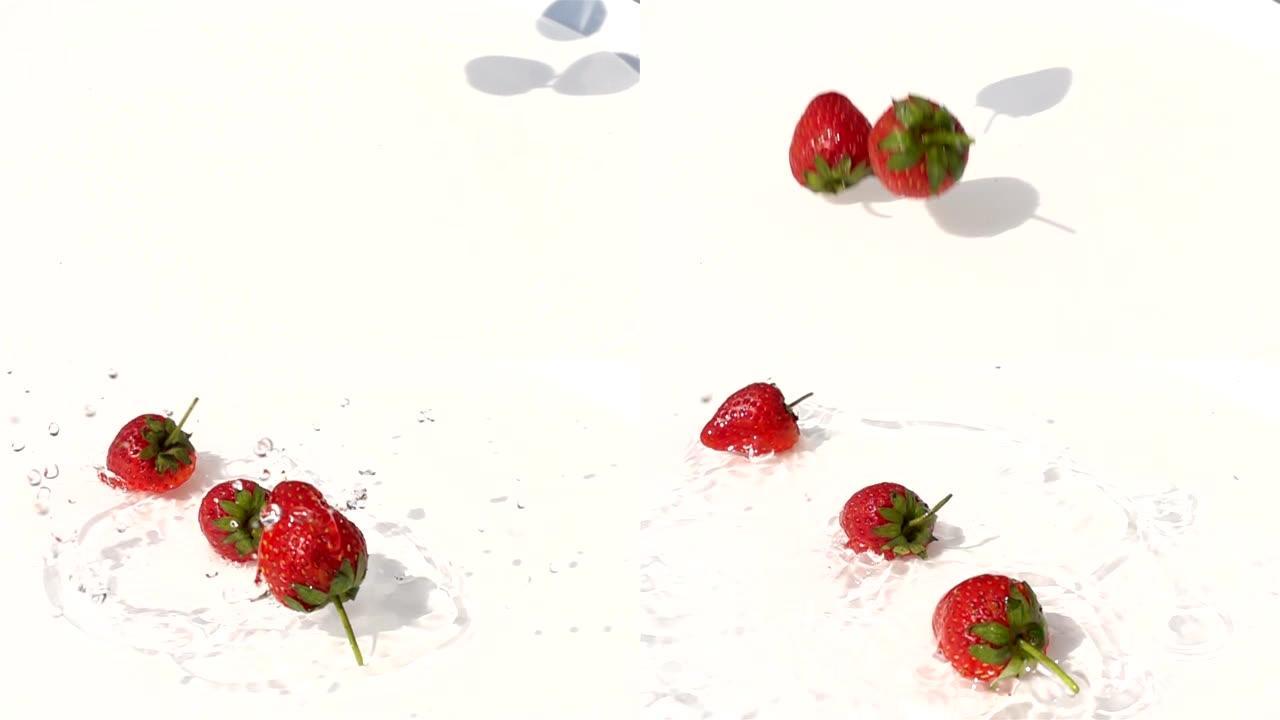 草莓落在白色盘子里的水面上