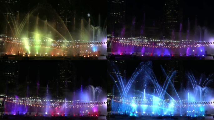 美丽的喷泉有光，夜空中喷泉的细射流升起，公园中的七彩灯喷泉，4k