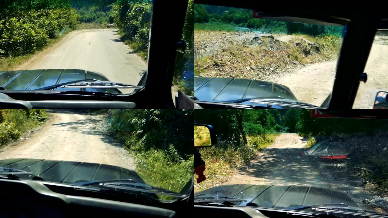 POV驾驶吉普车在绿色植物之间的崎岖道路上行驶