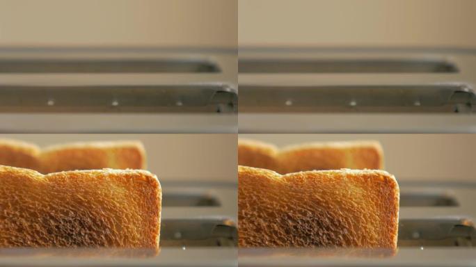 烤吐司面包从烤面包机中弹出，而烟雾冒出4K 2160p UHD素材-从烤面包机中弹出的两个吐司片4K