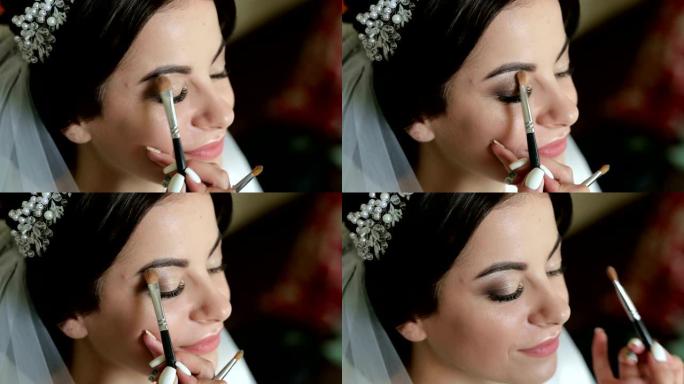 专业化妆师的特写镜头为新娘化妆。