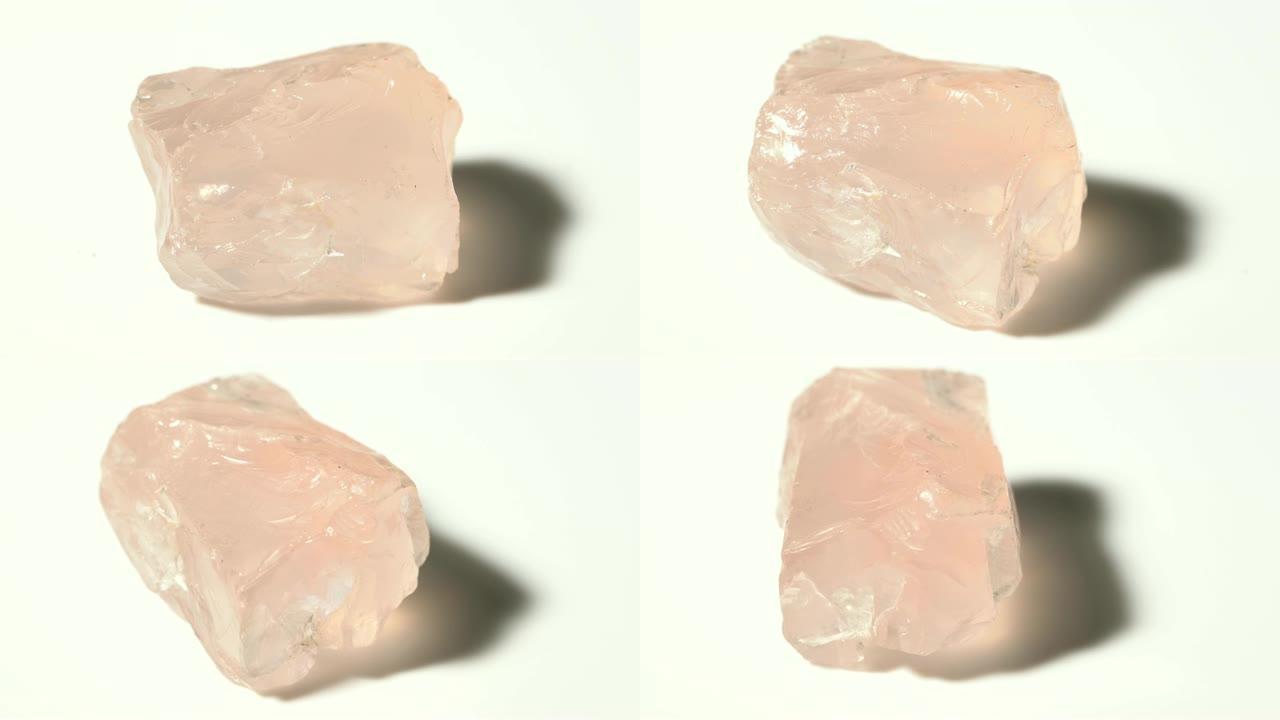 白色背景旋转的玫瑰石英矿物石材样品