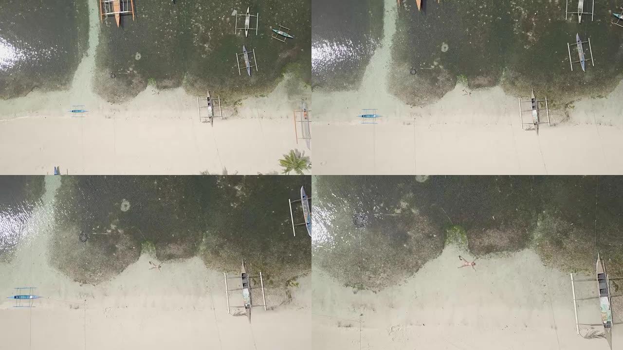 无人机在绿松石原始水中拍摄了热带岛屿和船只的鸟瞰图
