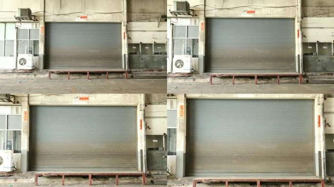 工厂、仓库、车库和工业仓库中使用的自动金属卷帘门特写镜头。波纹和可折叠金属板节省空间，并提供城市和乡