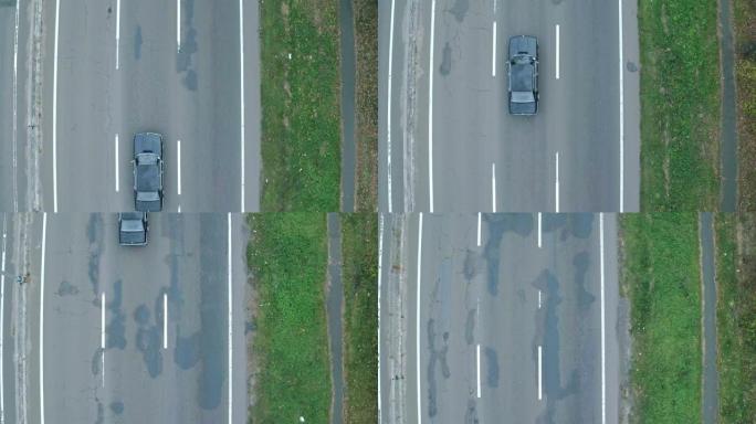 汽车的空中射击，在高速公路上。在高速公路上的复古黑色宝马的鸟瞰图