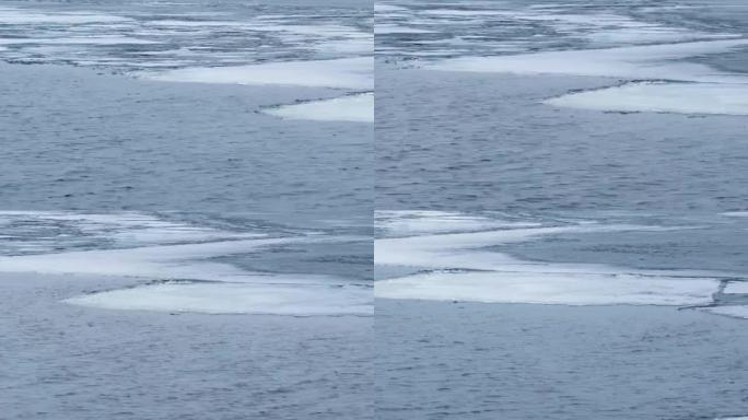 平移。部分冰冻的湖上的水波时光倒流