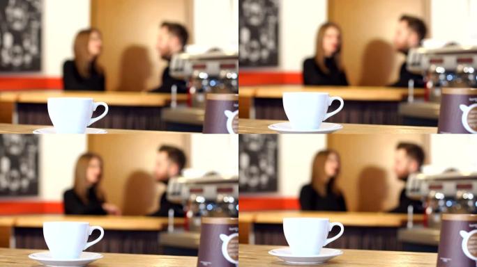 在cofee商店里，这对夫妇的背景是一杯咖啡。