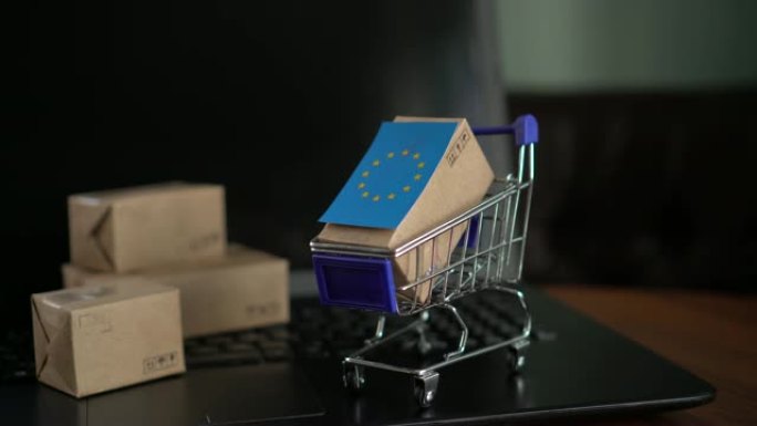 笔记本电脑键盘上的购物车中带有欧盟标志的邮政信箱