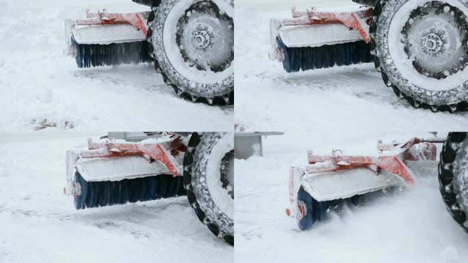 带有大刷子的拖拉机的特写镜头从城市街道上扫雪。