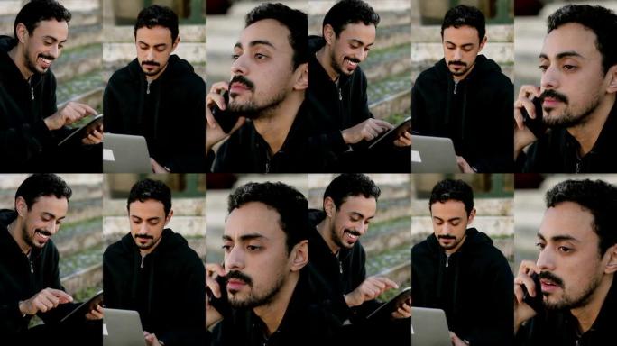 拥有数字设备的英俊年轻黑发。