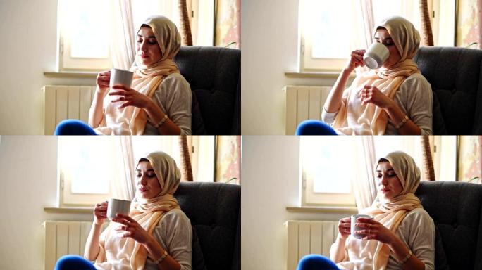 沙发上戴着面纱的伊斯兰妇女