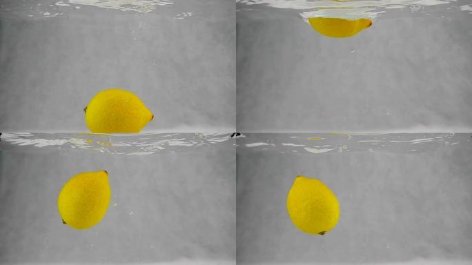 一个柠檬在慢动作中带着气泡掉入水中。在白色背景上分离的水果。