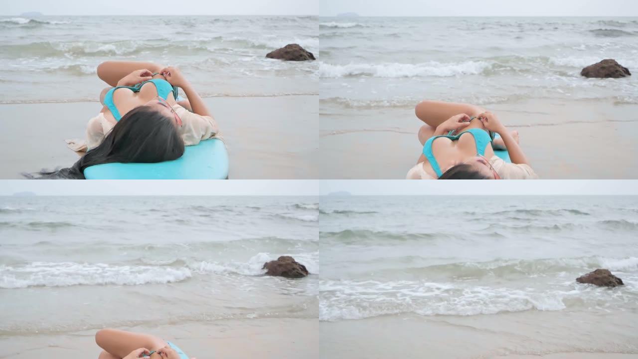 成年亚洲妇女在度假或夏天在热带海滩上放松。