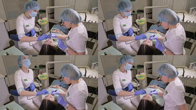 牙医诊所的女人接受牙科治疗以填补牙齿上的空洞。牙科修复和复合材料用紫外光和激光聚合。